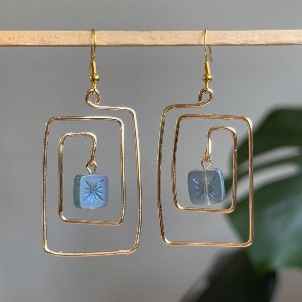 handmade gold wire spiral earrings with dangling blue czech square beads